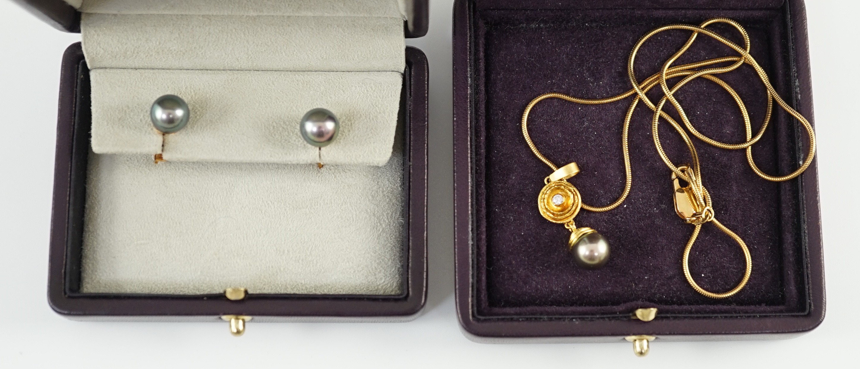 A modern textured gold, diamond and Tahitian pearl set drop pendant, on an 18ct gold snake link chain, in Asprey & Garrard box and a pair of 18ct gold and Tahitian pearl earrings, in Asprey & Garrard box